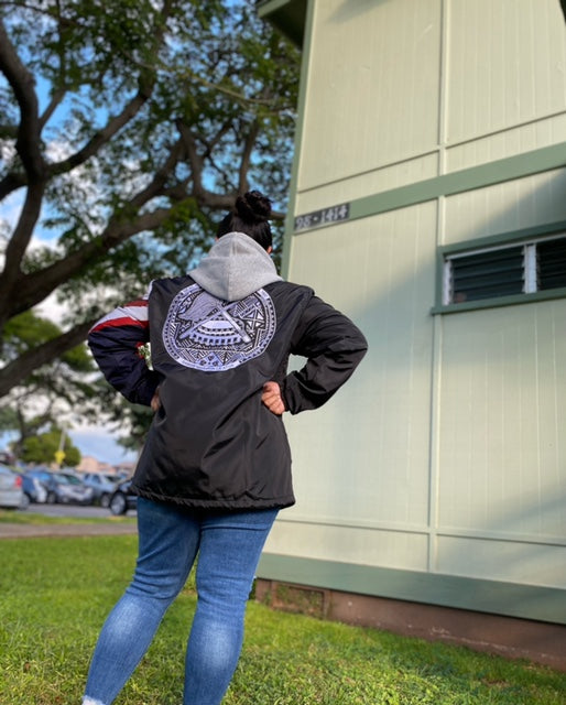 A woman showing off the back side of the Island Dynasty American Samoan Windbreaker