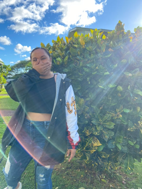 A woman wearing an Island Dynasty American Samoan Windbreaker 