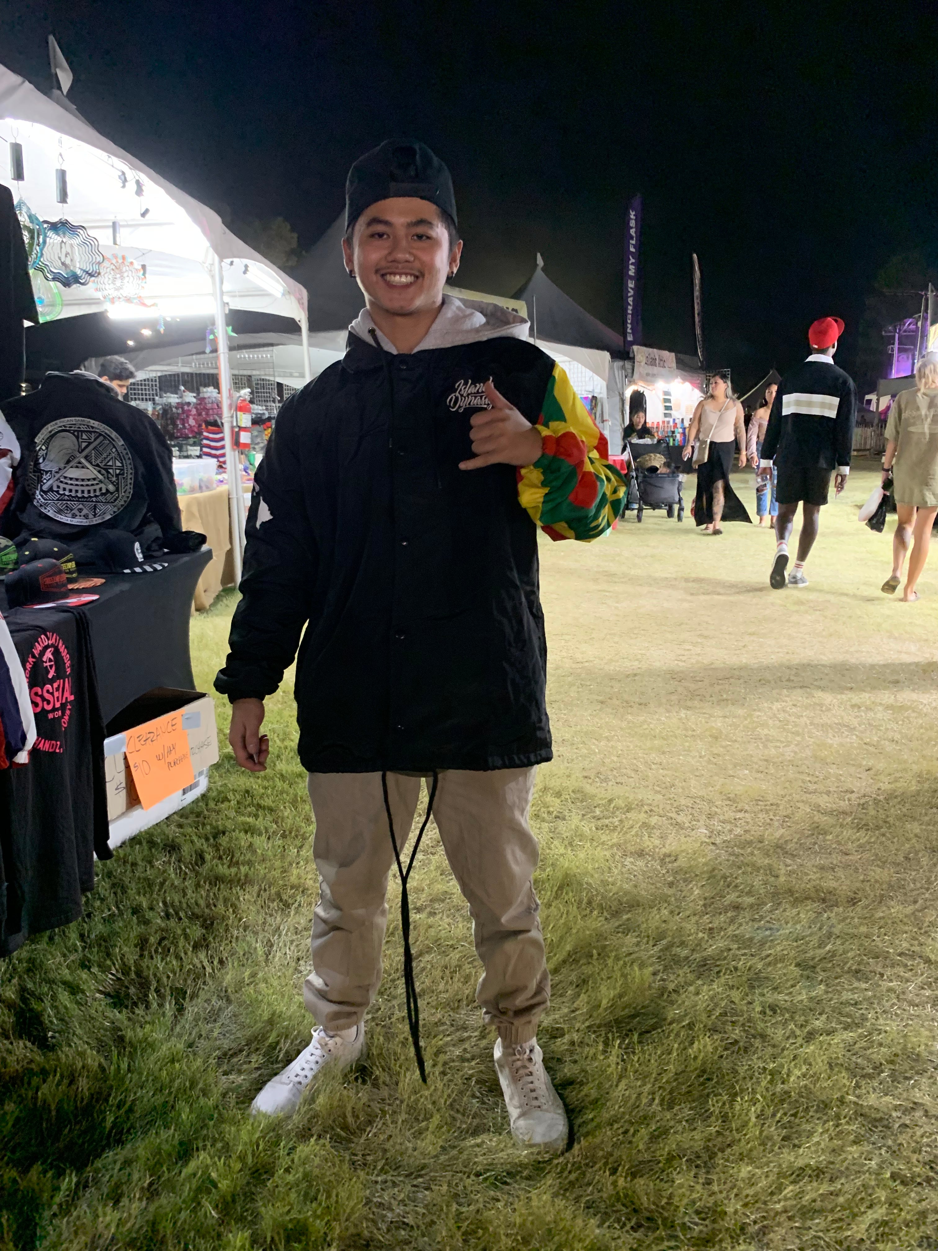 A young man wearing an Island Dynasty Kanaka Maoli Windbreaker