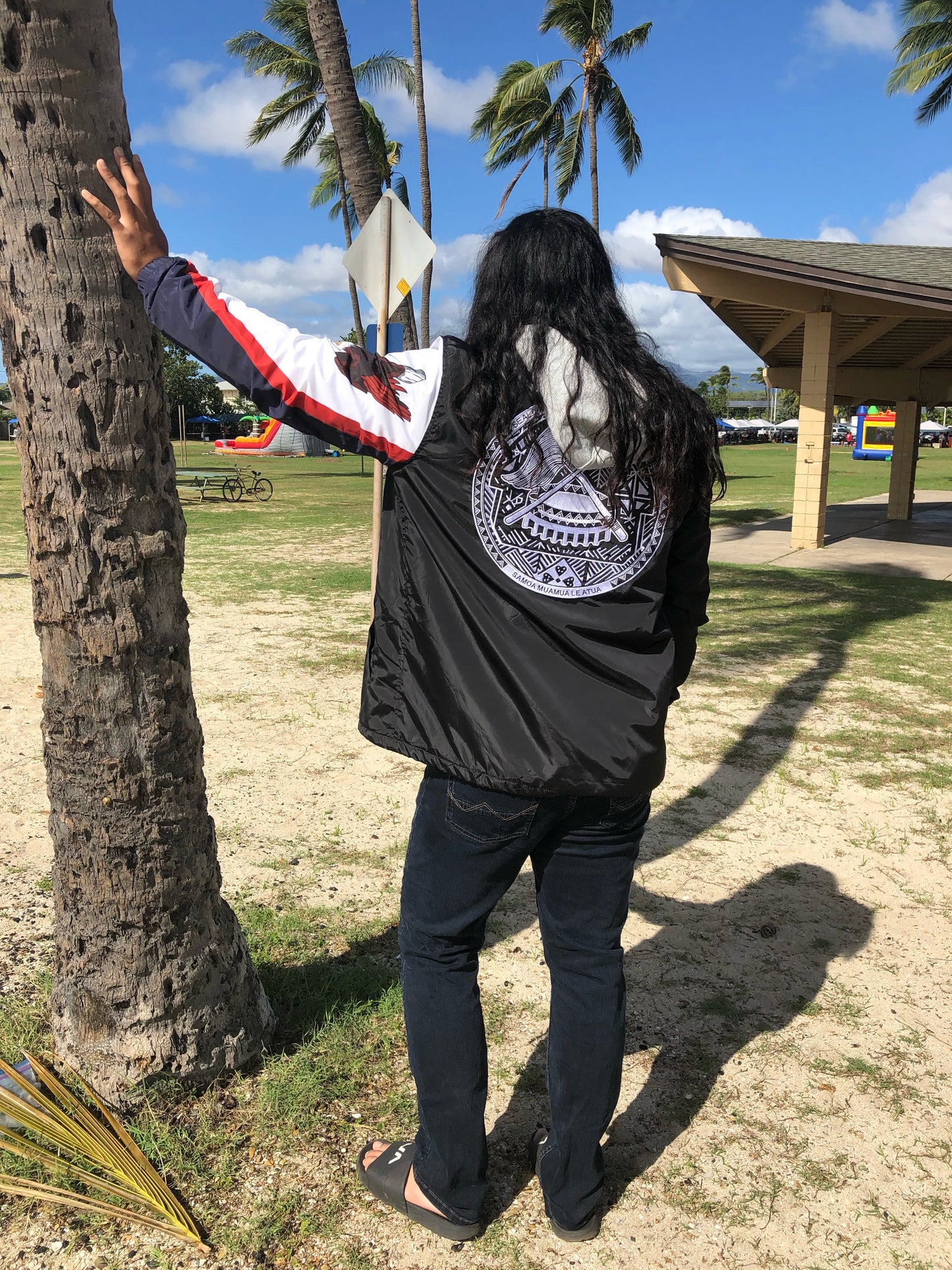 Island Dynasty Samoan Windbreaker - Island Dyansty Apparel OuterwearMen's Model showing off the back of the Island Dynasty American Samoan Flag Windbreaker at the beach