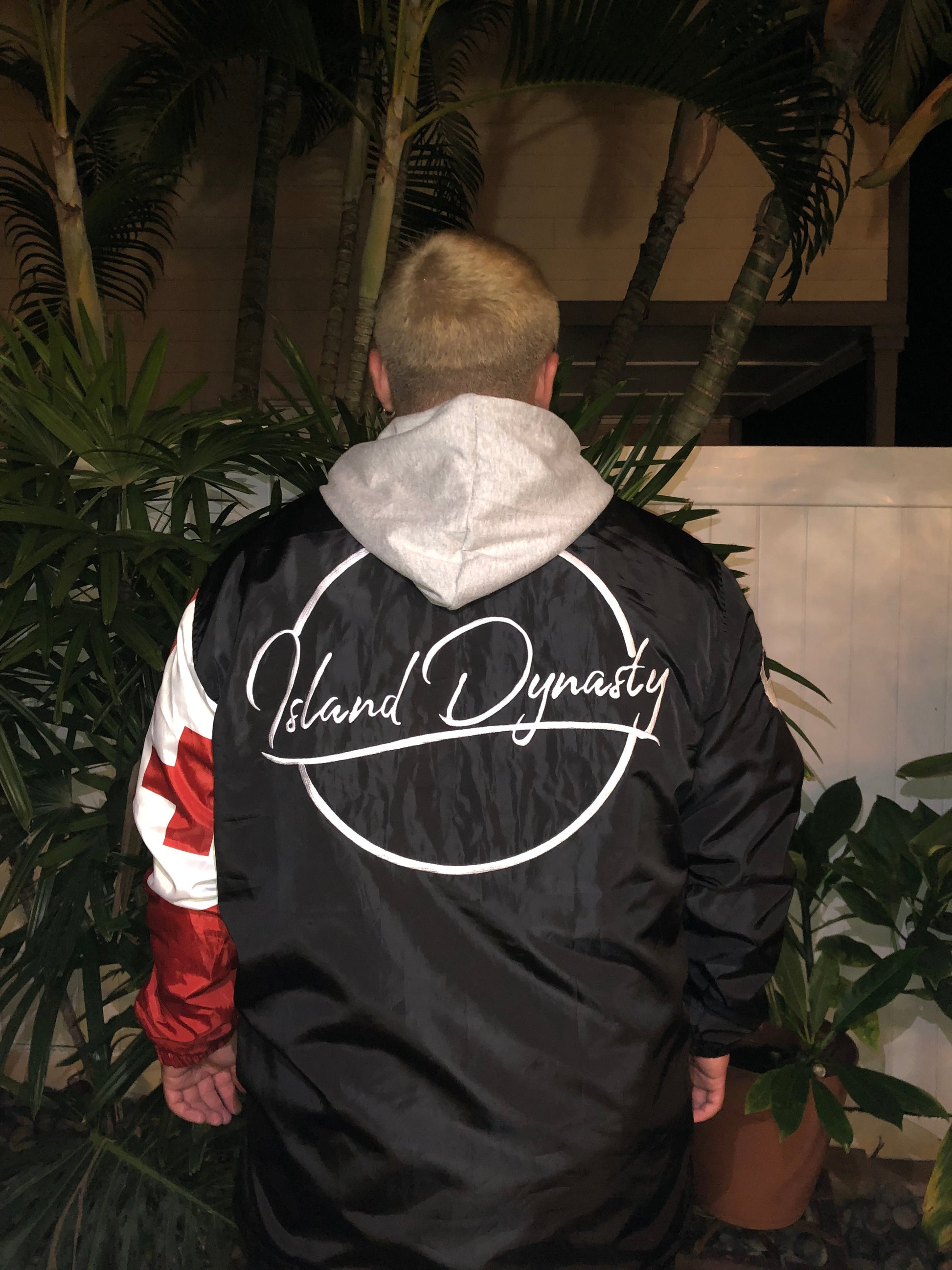 Island Dynasty Tongan Flag Windbreaker - Island Dyansty Apparel OuterwearMen's Model showing the back view of the Island Dynasty Tongan Flag Windbreaker displaying the embroidered Island Dynasty logo and the back of the Tongan flag on the left sleeve